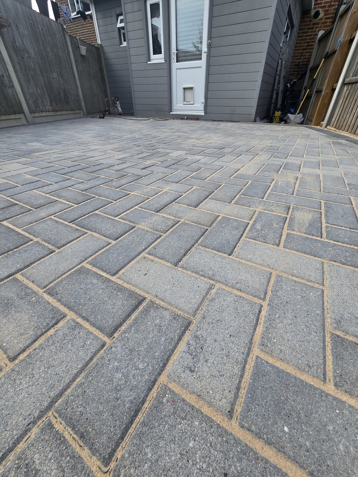 Clean, re-sanded block paving patio after a SafeTouch pressure wash