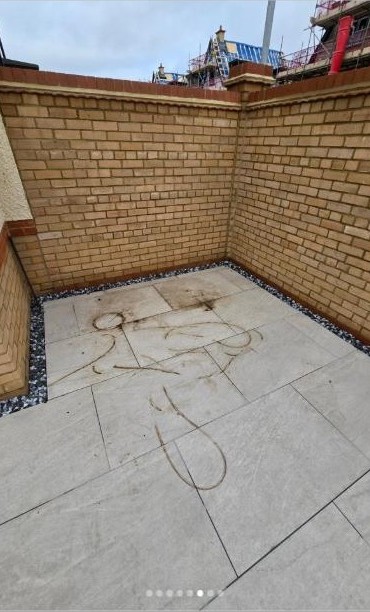 Tired, stained porcelain patio before cleaning